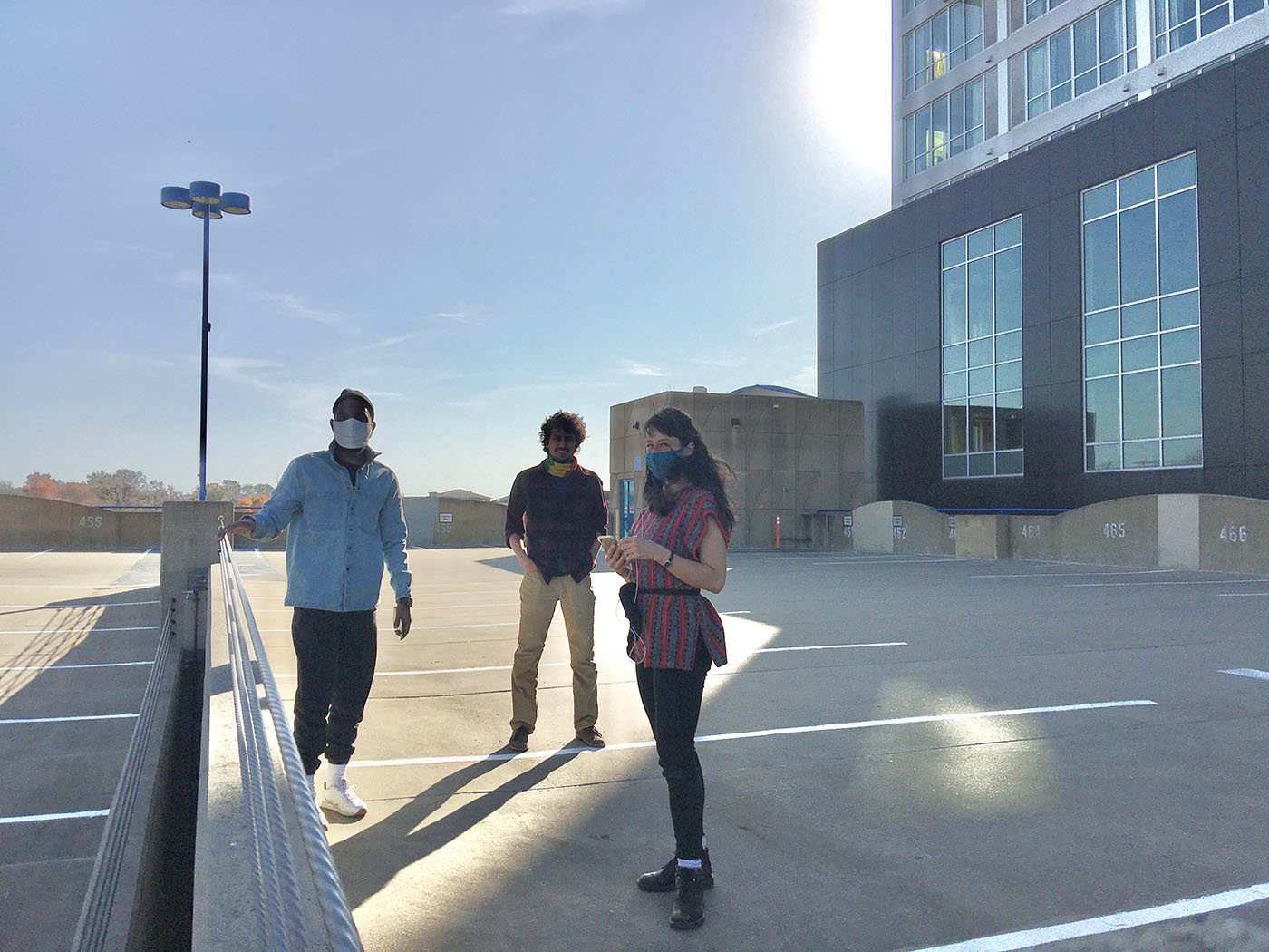 Pictured from left to right: Steven, Ramin, and Stephanie standing on the roof of the Chauncey Swan Parking Ramp located in Iowa City, Iowa.